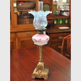 Oil Table Lamp | Period: c1900 | Material: Glass and Bronzed Iron | Floral Pattern on Font; Cherubs on Base.