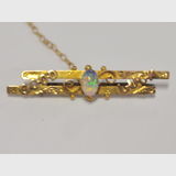 'Good Luck' Brooch | Period: 1888- 1925 | Make: Rollason & Co. Ltd. | Material: 9ct gold & cabachon cut opal