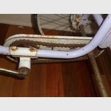 Child's Tricycle | Period: Vintage | Material: Steel & Tin; Solid rubber tyres | Close-up showing pedal and chain drive system