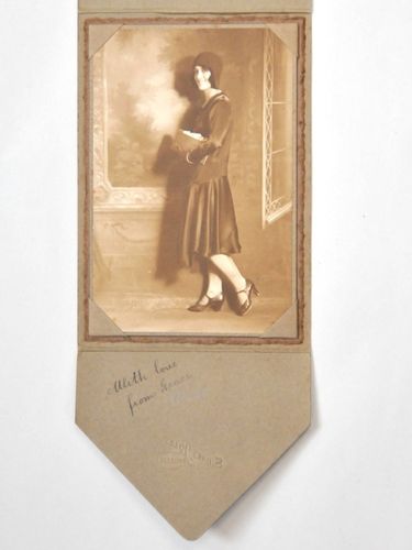 Flapper Girl Photograph | Period: 1925 | Make: Sidney Riley, Brisbane | Material: Sepia photograph mounted in cardboard presentation folder